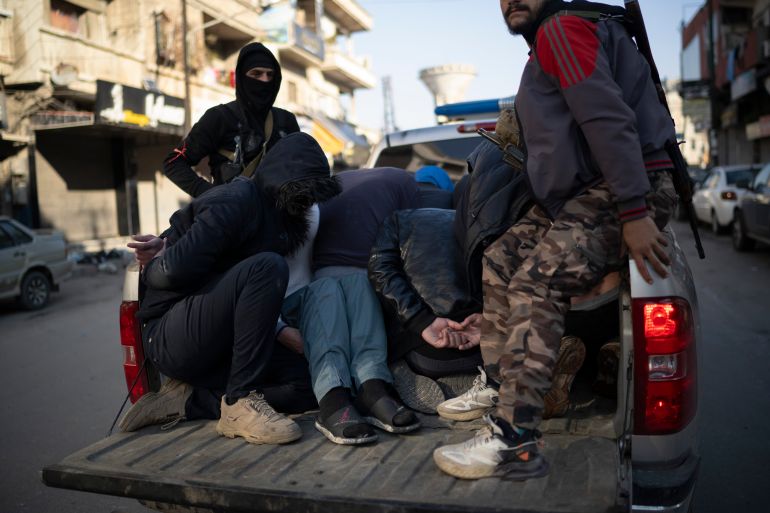 Members of the new security forces detain men suspected of being part of militias or loyalist soldiers of the ousted president Bashar Assad during an operation in Homs, Syria, Friday, Jan. 3, 2025. (AP Photo/Leo Correa)