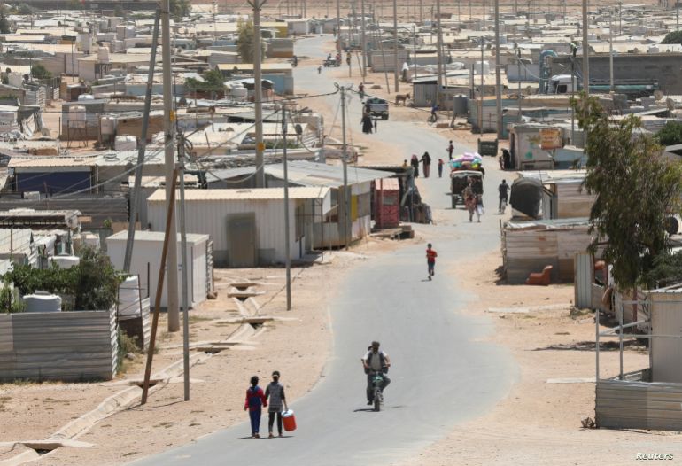 Syrian refugees walk at the Zaatari refugee camp in the Jordanian city of Mafraq, near the border with Syria, Jordan June 17, 2021. Picture taken June 17, 2021. REUTERS/Alaa Al Sukhni